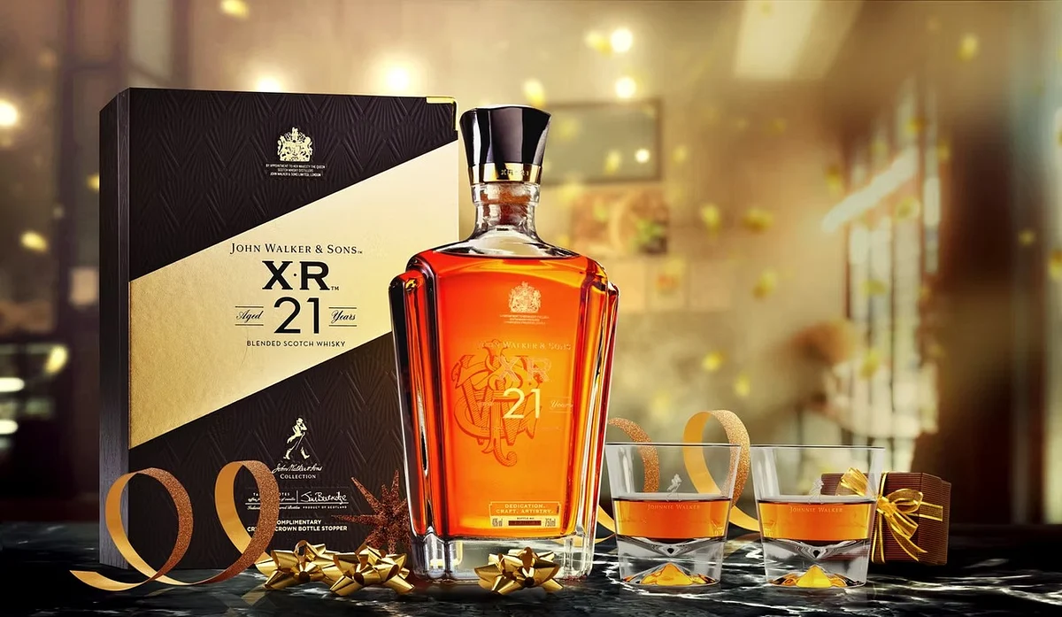John Walker & Sons XR 21 whisky bottle and box with two filled glasses